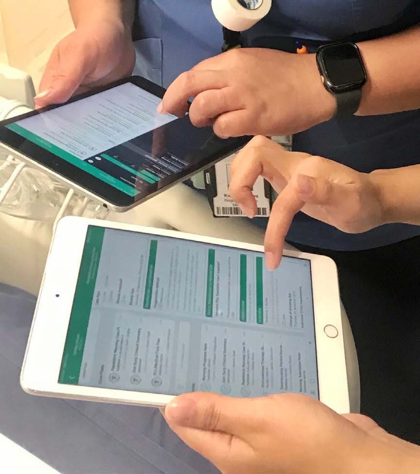 Two Burwood clinicians working side by side on iPads running Cortex